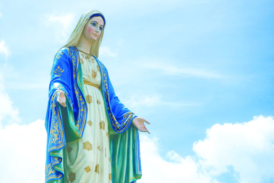 The Blessed Virgin Mary Statue blue sky background.