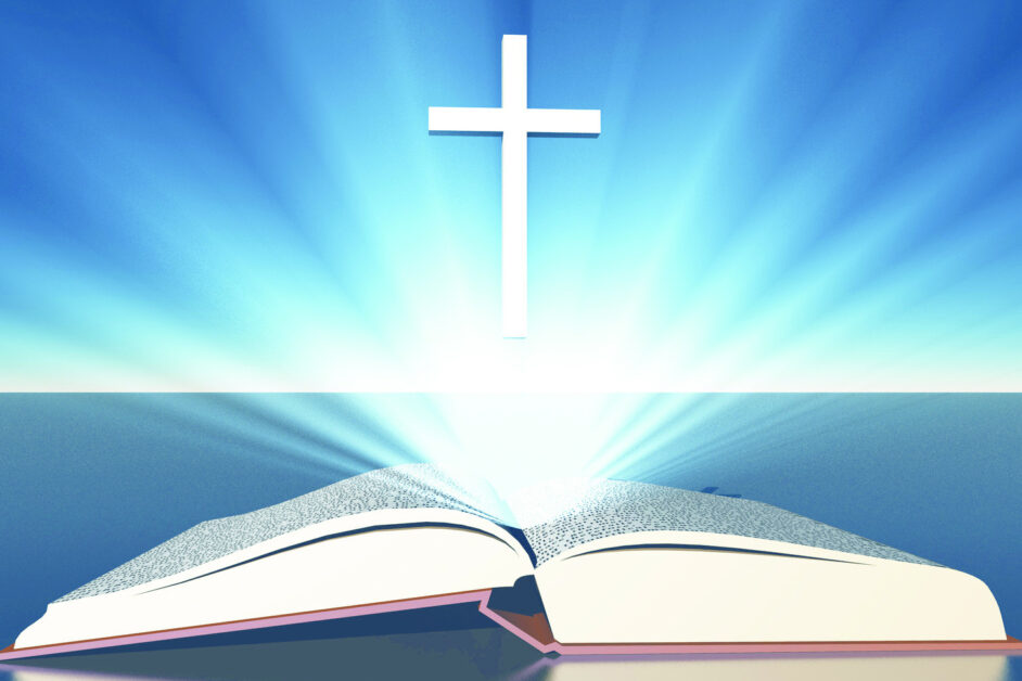 Light radiates from bible under cross