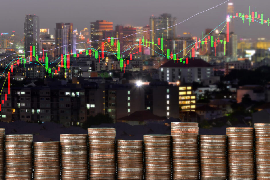 stack of coins with business graph and modern night city backgro